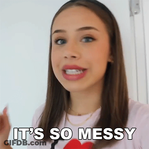 A Woman Is Saying It 'S So Messy While Holding A Red Heart . GIF