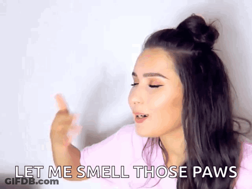 A Woman Is Saying Let Me Smell Those Paws . GIF