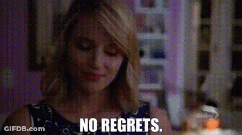 A Woman Is Saying No Regrets While Looking Down At Something . GIF