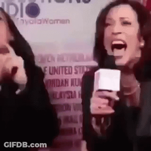 A Woman Is Screaming Into A Microphone In Front Of A Sign That Says United States . GIF