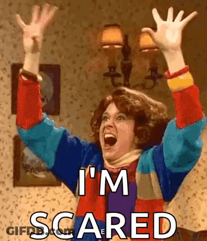 A Woman Is Screaming With Her Arms In The Air And The Words I 'M Scared Above Her GIF
