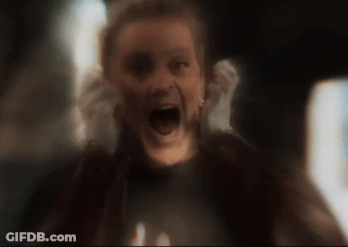A Woman Is Screaming With Her Mouth Wide Open In A Blurry Photo . GIF