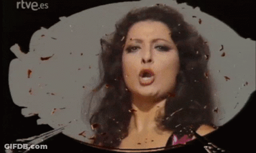 A Woman Is Singing In Front Of A Rtve.es Logo GIF