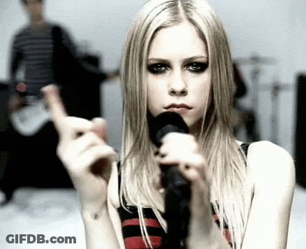 A Woman Is Singing Into A Microphone And Making A Funny Face GIF