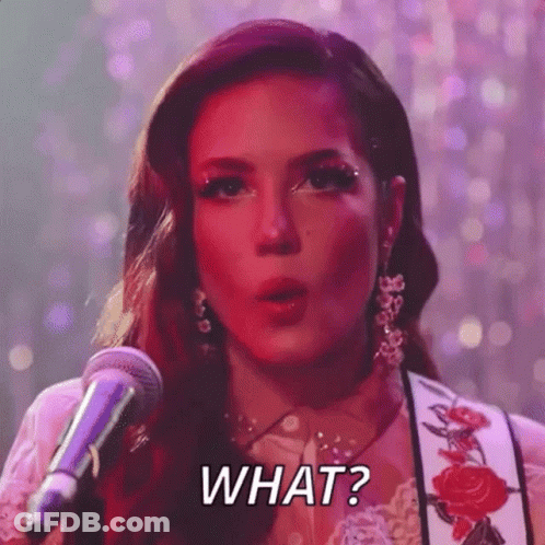 A Woman Is Singing Into A Microphone And Saying `` What ? '' . GIF
