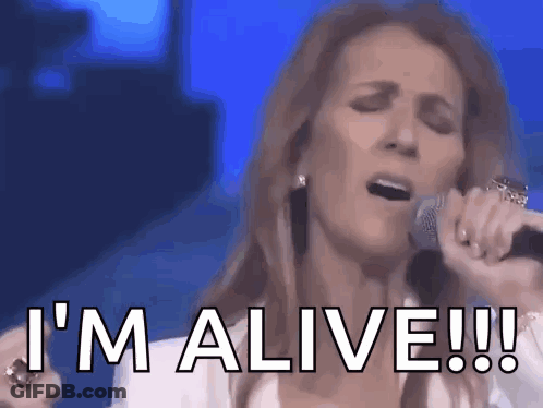 A Woman Is Singing Into A Microphone And Says I 'M Alive ! GIF