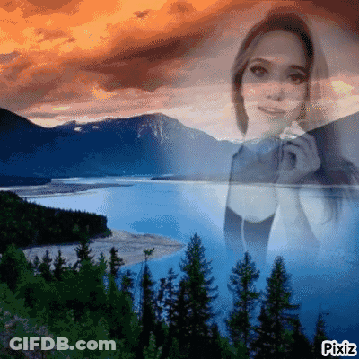 A Woman Is Singing Into A Microphone In Front Of A Lake . GIF
