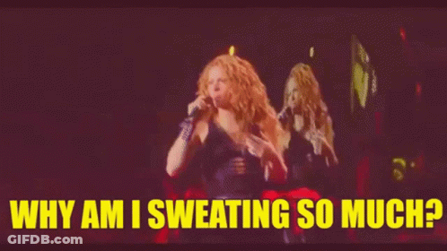 A Woman Is Singing Into A Microphone On A Stage And The Words `` Why Am I Sweating So Much '' Are Above Her . GIF