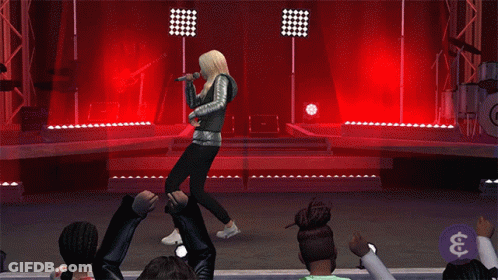 A Woman Is Singing Into A Microphone On A Stage In Front Of A Crowd GIF