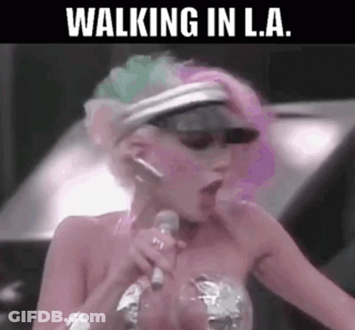 A Woman Is Singing Into A Microphone With Her Mouth Open . GIF