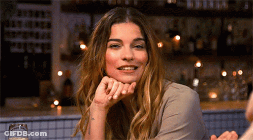 Woman Smiling Sitting At Bar GIF