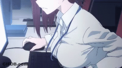 A Woman Is Sitting At A Desk Using A Computer And Mouse GIF