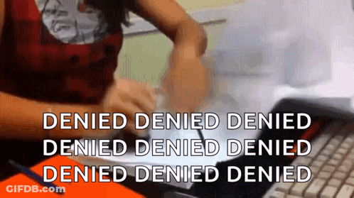 A Woman Is Sitting At A Desk Using A Laptop Computer With The Words Denied Denied Denied Denied Denied Denied Denied GIF