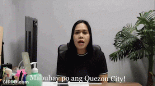 A Woman Is Sitting At A Desk With A Bottle Of Hand Sanitizer In Front Of Her And Says Mabuhay Po Ang Quezon City GIF