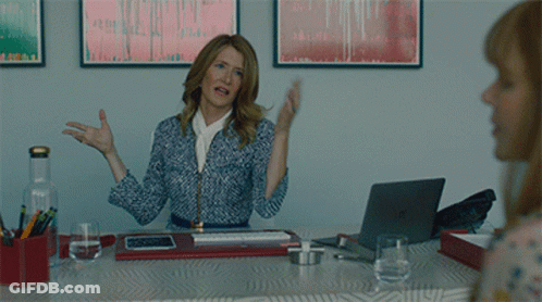 A Woman Is Sitting At A Desk With A Laptop And A Bottle Of Water GIF