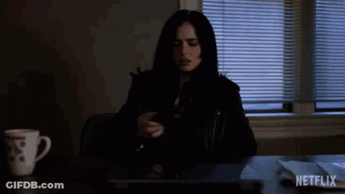 A Woman Is Sitting At A Desk With A Laptop And A Cup Of Coffee And A Netflix Logo In The Corner . GIF
