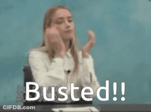 A Woman Is Sitting At A Desk With Her Hands On Her Face And The Words Busted Written In Front Of Her . GIF