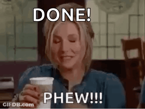 A Woman Is Sitting At A Table Holding A Cup Of Coffee And Making A Funny Face . GIF