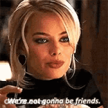 A Woman Is Sitting At A Table Holding A Glass Of Wine And Saying `` We 'Re Not Gonna Be Friends . '' GIF