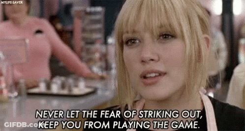 A Woman Is Sitting At A Table In A Restaurant With A Quote On Her Face . GIF