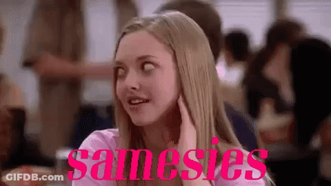 A Woman Is Sitting At A Table In A Restaurant With The Word Samesies Written On The Bottom Of Her Face . GIF