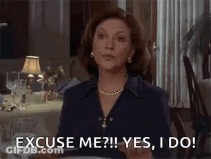 A Woman Is Sitting At A Table Saying `` Excuse Me ? Yes , I Do ! `` GIF