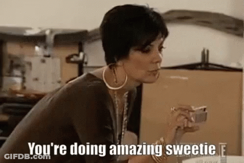 A Woman Is Sitting At A Table Smoking A Cigarette And Holding A Cup Of Coffee . GIF
