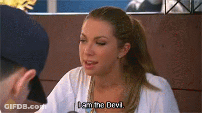 A Woman Is Sitting At A Table Talking To A Man And Saying `` I Am The Devil . '' GIF