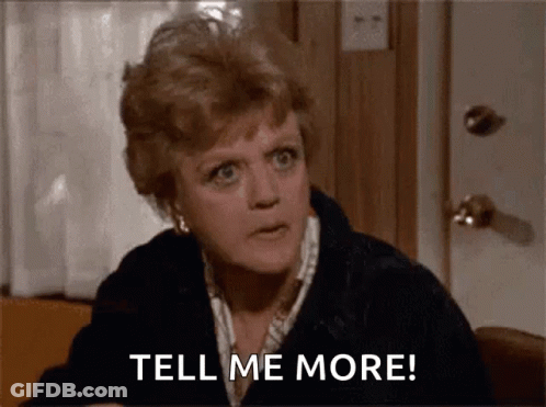 A Woman Is Sitting At A Table Talking To Someone And Says `` Tell Me More '' . GIF