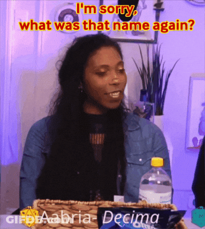 A Woman Is Sitting At A Table With A Bottle Of Water And A Box Of Aaoria-Decimo Cookies GIF