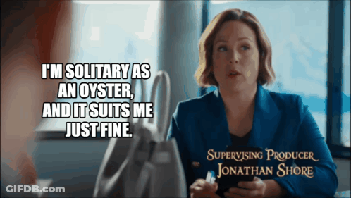 A Woman Is Sitting At A Table With A Caption That Says " I 'M Solitary As An Oyster " GIF