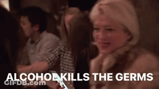 A Woman Is Sitting At A Table With A Cell Phone In Her Hand And A Group Of People Are Sitting Around Her . GIF