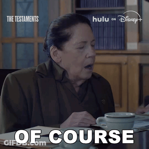 A Woman Is Sitting At A Table With A Cup Of Coffee And The Words Of Course Written On The Bottom GIF