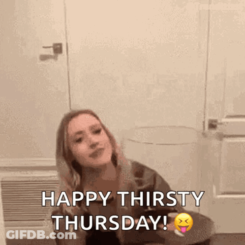 A Woman Is Sitting At A Table With A Glass Of Wine And The Words Happy Thirsty Thursday . GIF