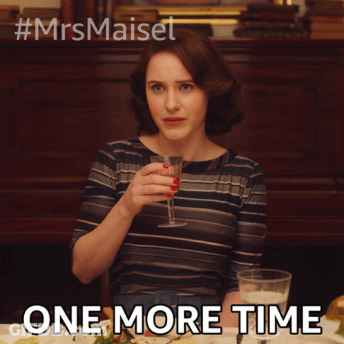 A Woman Is Sitting At A Table With A Glass Of Wine And The Words One More Time Below Her GIF