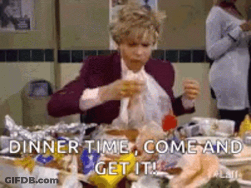 A Woman Is Sitting At A Table With A Lot Of Food And Eating . GIF
