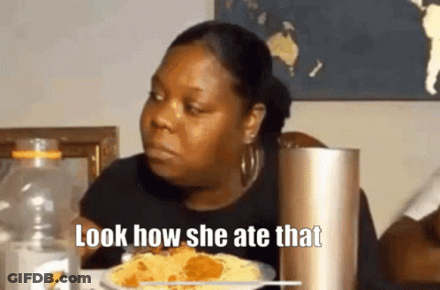 A Woman Is Sitting At A Table With A Plate Of Food And A Bottle Of Gatorade . GIF