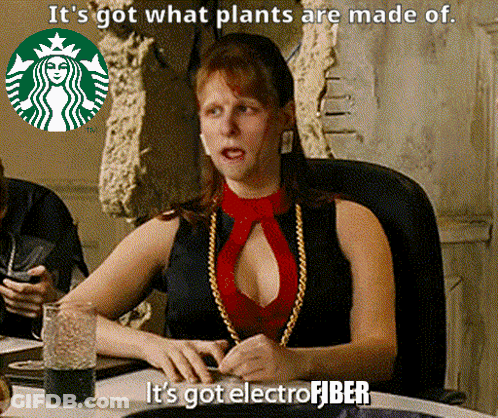 A Woman Is Sitting At A Table With A Starbucks Logo In The Background And Says It 'S Got What Plants Are Made Of GIF