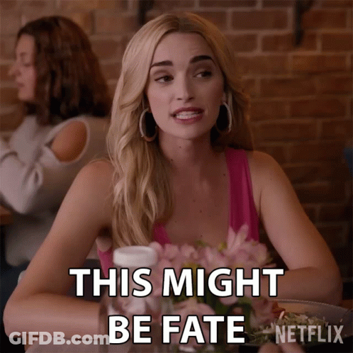 A Woman Is Sitting At A Table With Flowers And Says This Might Be Fate GIF