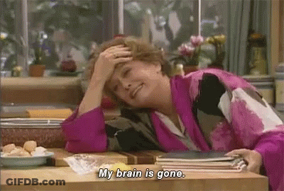 A Woman Is Sitting At A Table With Her Hand On Her Forehead And Saying `` My Brain Is Gone . '' GIF