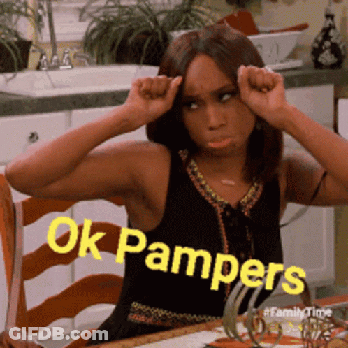 A Woman Is Sitting At A Table With Her Hands On Her Head And The Words Ok Pampers Written On The Bottom GIF