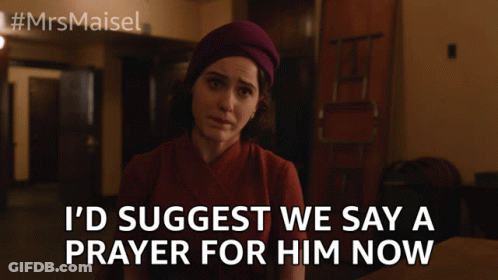 A Woman Is Sitting At A Table With The Words I 'D Suggest We Say A Prayer For Him Now GIF