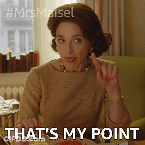 A Woman Is Sitting At A Table With The Words That 'S My Point Written Below Her GIF