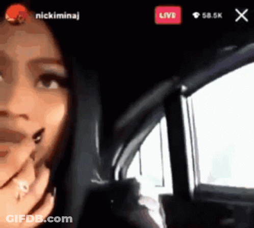 A Woman Is Sitting In A Car With A Live Button Above Her GIF