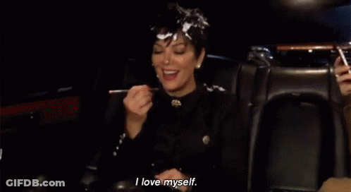 A Woman Is Sitting In A Car With A Spoon In Her Mouth . GIF