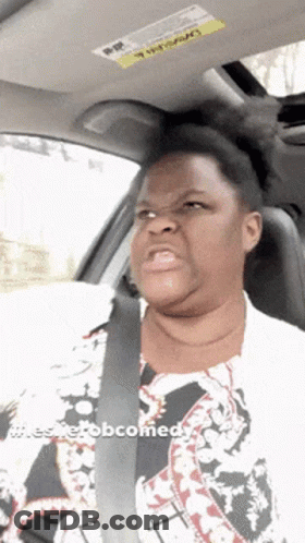 A Woman Is Sitting In A Car With A Sticker On The Roof That Says Warning GIF