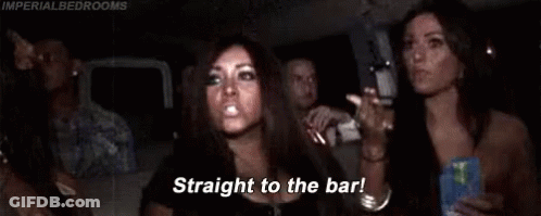 A Woman Is Sitting In A Car With Her Arms In The Air And A Group Of People . GIF