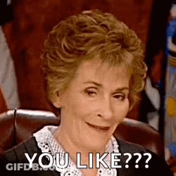 A Woman Is Sitting In A Chair And Smiling While Saying `` You Like ? '' . GIF