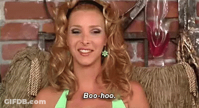 A Woman Is Sitting In A Chair And Smiling While Wearing A Green Top . GIF