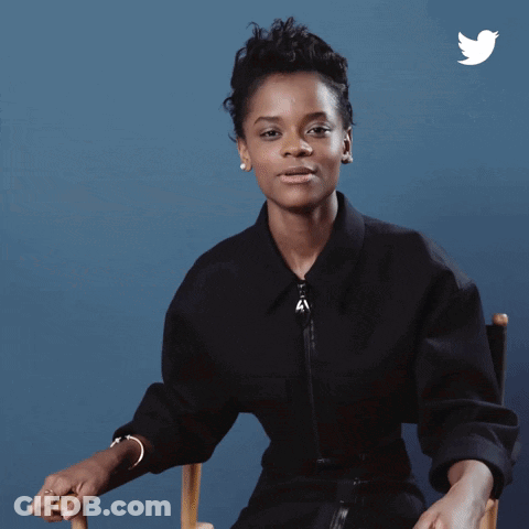 A Woman Is Sitting In A Chair And The Word Wakanda Is On The Bottom GIF